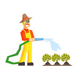 Man Watering The Garden Bed With Hose