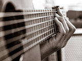 Closeup of playing an acoustic guitar