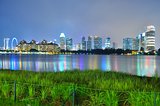 Greenery by Kallang River, with skyline and colourful reflections in the background