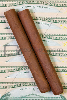 US dollar banknotes and Cuban cigars