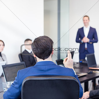 Colleague asking question to business team leader.
