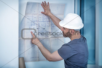 Architect builder studying layout plan of the rooms