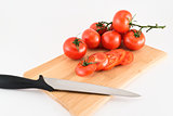 Cutting red tomatoes composition background