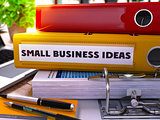 Small Business Ideas on Yellow Office Folder. Toned Image.