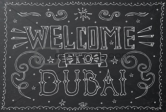 Welcome to Dubai. Hand drawn vintage lettering on black chalkboa