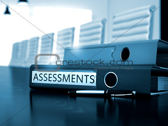 Assessments on Office Binder. Blurred Image.
