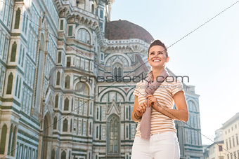 Woman tourist standing near Duomo and looking into distance