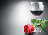 Glass of wine and rose flower