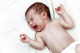 Newborn baby crying in white bad