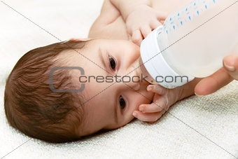 Newborn baby eating from the plastic bottle