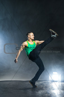 Dancer posing on background with flashes and smoke