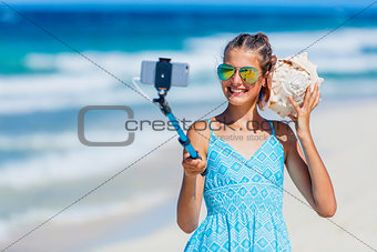 Girl with shell at the beach