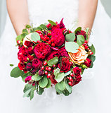 Beautiful wedding bouquet in hands of the bride close-up
