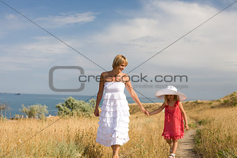Happy family resting at beach in summer mother with daughter