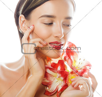 young pretty brunette woman with red flower, amaryllis. close up isolated on white background. Fancy fashion makeup, bright lipstick, creative Ombre manicured nails