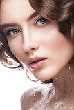 Portrait of beautiful girl with a gentle makeup, curls and crystals on the body. beauty face.