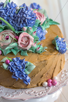 Festive cake with flowers of cream closeup.