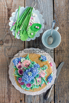 Dish with cake and decorative elements from sugar mastic.