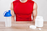 Closeup on a man with nutiotion supplements on table