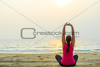 sports by the ocean. woman doing yoga