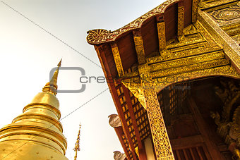Chapel of Thai temple and Golden Pagoda at Wat Pra Singh Chaingmai Thailand