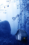 Wooden house and mysterious landscape of foggy forest 