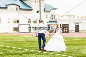 European Football Championship concept. Wedding couple on the football stadium.