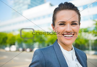 Portrait of smiling business woman in modern office district