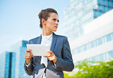 Portrait of business woman with tablet PC in office district