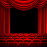 an auditorium with a red curtain