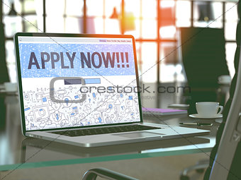 Apply Now on Laptop in Modern Workplace Background.