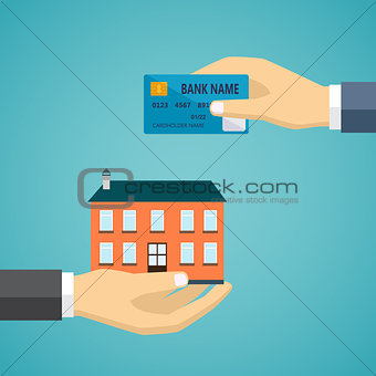 Hand with credit card and hand with house.