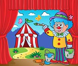 Clown painting image of circus on stage