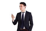 Young Caucasian business man looking at mobile phone