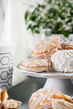 Biscuits on gray plate with cups of coffee with green and white 