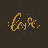 Golden hand lettering of the word LOVE.
