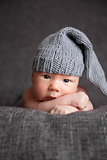 Beautiful newborn wearing a cute grey hat
