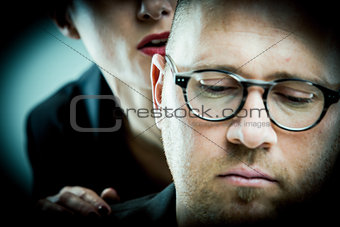 woman whispering to man