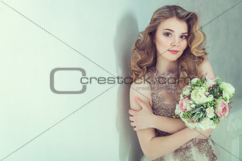 Portrait of beautiful blonde woman with curly hairstyle. Studio shoot.
