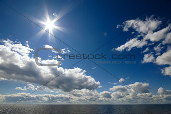 Blue sky with clouds over sea
