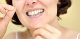 Woman flossing her teeth 