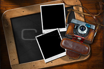 Old Camera with Empty Photos and Blackboard