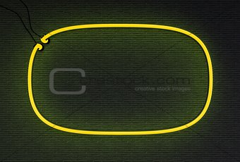 Yellow neon frame isolated on black wall background
