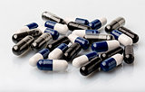 Various medical dosage capsule black and blue