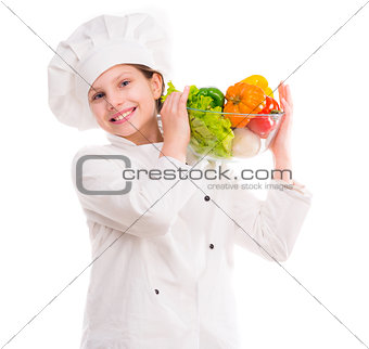 little girl-cook with bowl of vegetables on shoulder