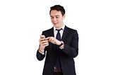 Young Caucasian business man looking at mobile phone smiling