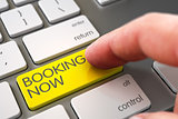 Hand Touching Booking Now Button.