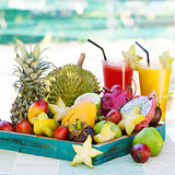 Assortment of tropical exotic fruits with smoothie and fresh juice
