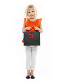 Blond girl in orange shirt with shopping bag on white background