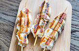 Grilled chicken skewers on the wooden board